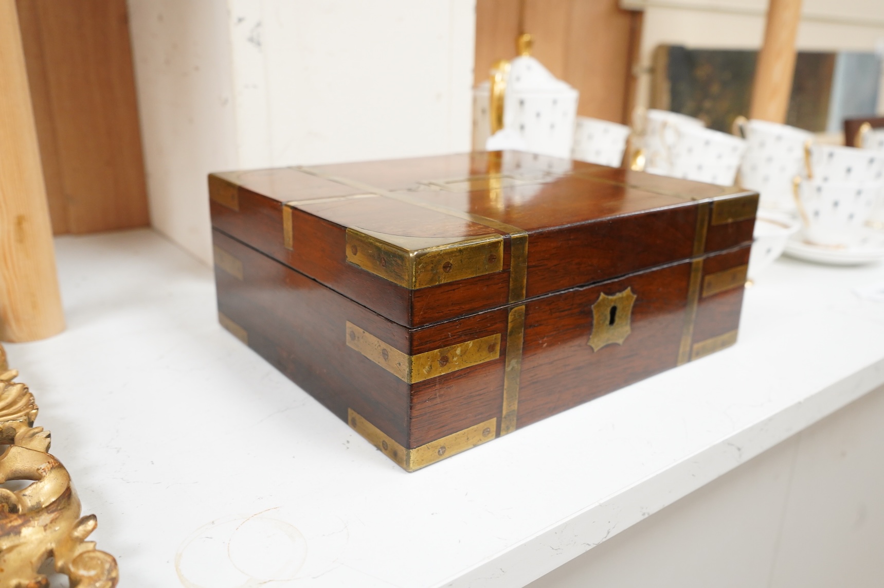 A George IV mahogany and brass bound campaign vanity box with original fittings, 27cm wide x 23cm deep x 10cm high